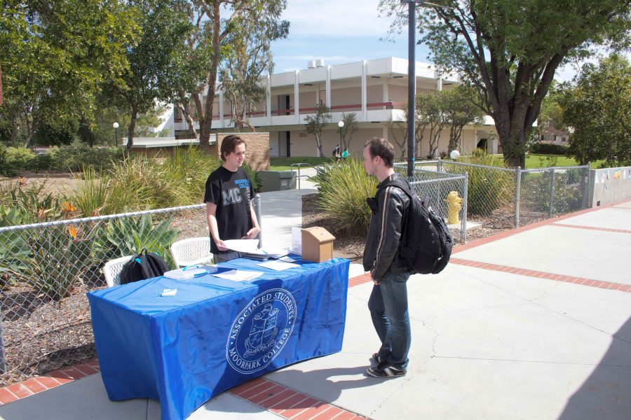 Andrew Anderson, left, helps student like Ethan Lieberman realize how they can become more involved in their school through his promotion of the Associated Students elections.