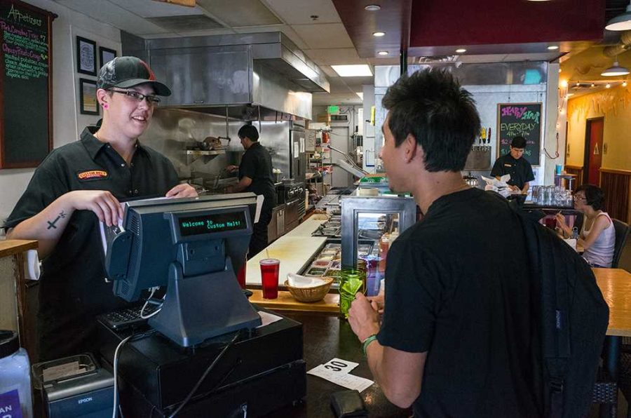 Moorpark College student Sebastian Montoya Vega (right), 22, orders a sandwich from Manager Kelly Gordon at the Custom Melt restaurant in Moorpark on September 18.