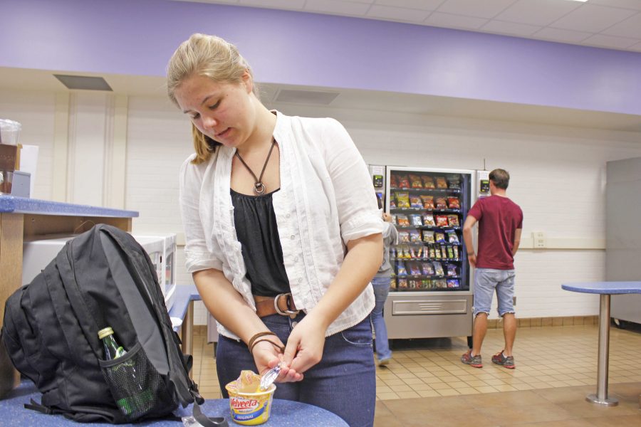 Hannah Wallace, 18, student at the High School at Moorpark College, heats up macaroni and cheese purchased from a vending machine before going to class. Photo credit: ariana duenas