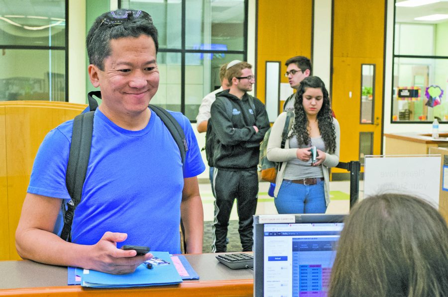 Nolan Galeon waits to schedule a counseling appointment along with several other students in Fountain Hall. Photo credit: Travis Wesley