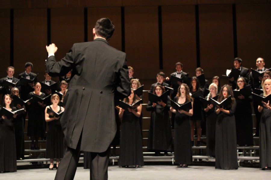 Brandon Elliott conducts the Concert Choir and Vocal Ensemble during their opening number Tambar at their Choral Concert Sunday, Nov. 2.