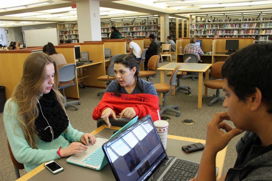 Kelsey Anderson, from left, Jordan Haddad, and Nick Moreno looking at video auditions in the Moorpark College library in preparation for their upcoming web series "Miles to Go." Photo credit: Samantha Wulff