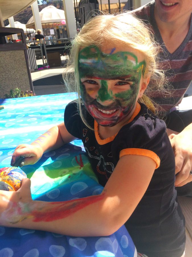3-year-old, Kara, enjoys painting her own face at Moorpark College Discovery Day. Photo credit: Jackie Stone