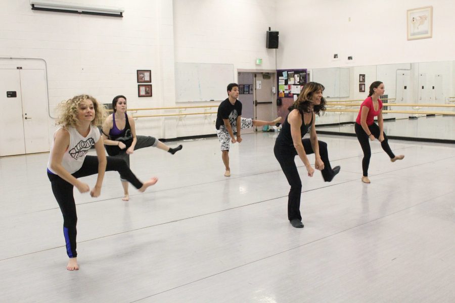 Professor Nancy Paradis guides her dancers through choreography for their upcoming performance with the Wind Ensemble. 