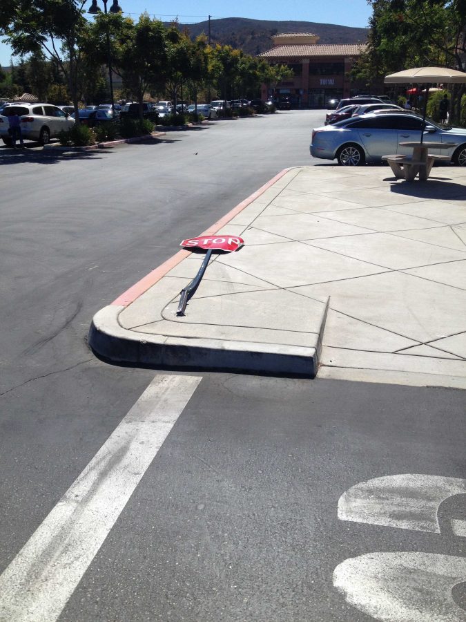 Stop sign in Campus Plaza after an unknown driver jumped the curb and ran it over in early October. Photo credit: Samantha Wulff