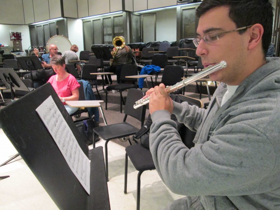 Music major Chase Rizkalla, 18, plays the flute during the Wind Ensemble rehearsal. Photo credit: Audrey Arellano