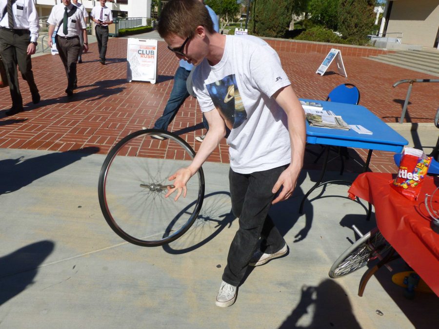 Eric Cole, 21, attempts to make the spinning gyroscope stay in vertical orientation through angular momentum. Photo credit: Jessica Frantzides