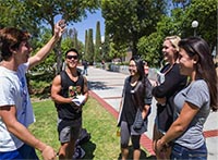 Tristan Lyga, left, 18, shares a funny story with friends along Raider Walk at Moorpark College that was ranked 35 by thebestschools.org.  Photo by Travis Wesley.