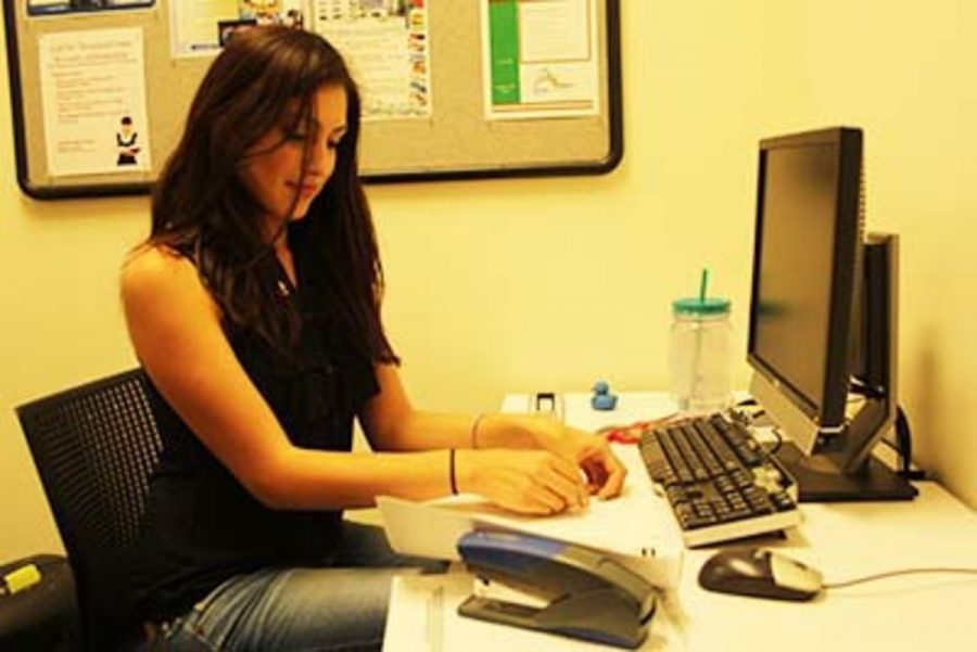 Business major Lilia Trevino-Gonzalez working in the scholarship office. Photo credit: Frank Ralph