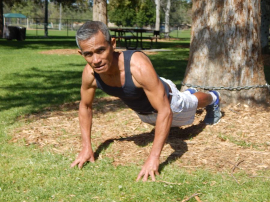 Minley+Abuyabor%2C+62%2C+warms+up+before+his+running+and+exercise+routine+at+a+local+park+in+Simi+Valley.+He+specializes+in+physical+training+for+boxing%2C+which+includes+running%2C+biking%2C+skipping+rope%2C+and+shadow+boxing.+Photo+credit%3A+Brian+King