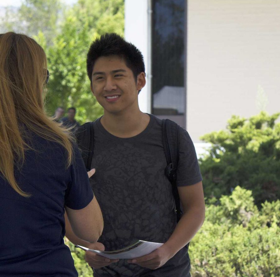 Kevin Nguyen,19, a biology major talks to a UC Davis representative about what is required to transfer.