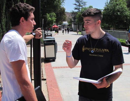 P.T.K. President Daniel Ruchman (right) talks about scholarships with student Gino Colella. Photo credit: Frank Ralph