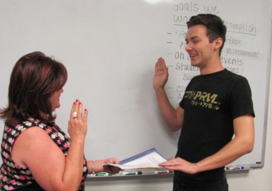William Sloane (right) is sworn in as Student Services Director by Sharon Miller, the A.S. advisor. Photo credit: Son Ly