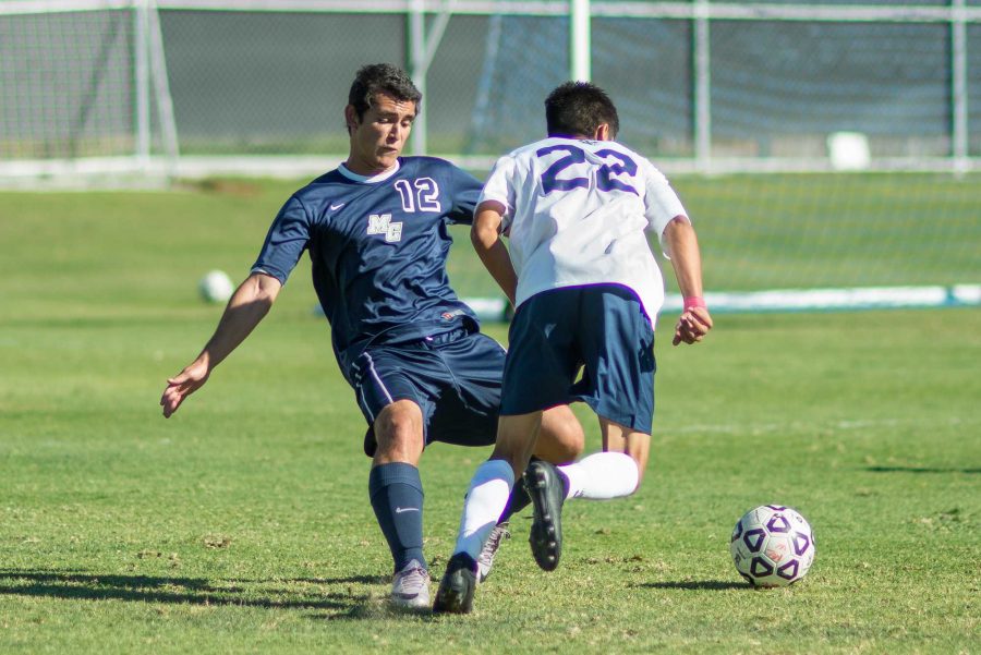 Roy Galdamez attempts to kick the ball from a Mission College midfielder.