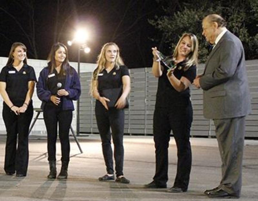 Interim Chancellor Bernard Luskin receives the Platinum Paw award at the previous Rendezvous at the Zoo  