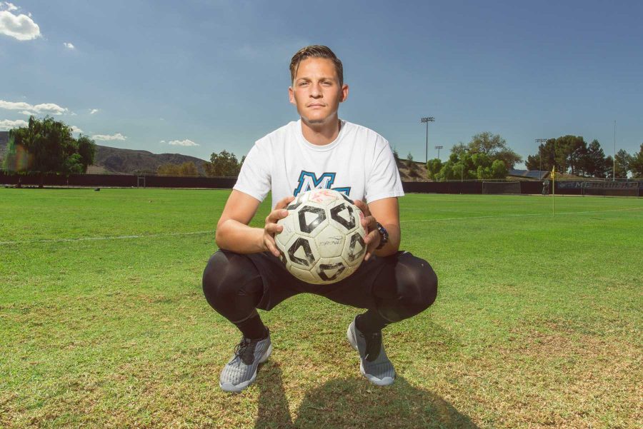 Moorpark+goalkeeper%2C+Daniel+Moreno%2C+poses+with+a+ball+in+front+of+Moorparks+soccer+field.+Photo+credit%3A+James+Schaap