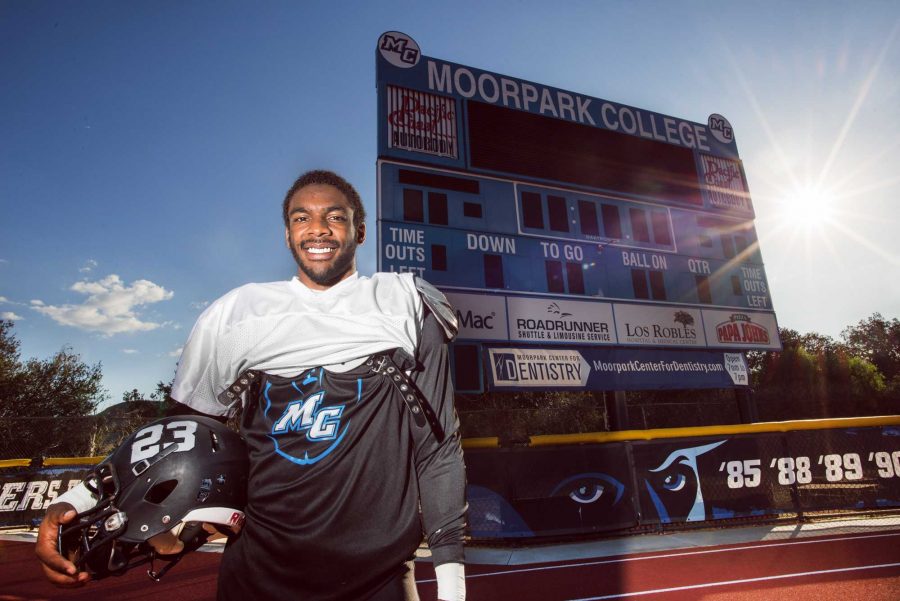 Running back, Isiah Johnson, poses in front of the Moorpark College scoreboard. Photo credit: James Schaap