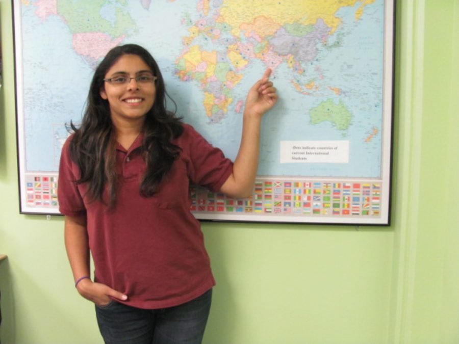 Aditi+Bhatnagar%2C+19%2C+psychology+major%2C+points+at+her+country+on+a+world+map.+She+will+give+a+presentation+on+India+on+Nov.+17.+as+part+of+the+International+Education+Week.+Photo+credit%3A+Son+Ly