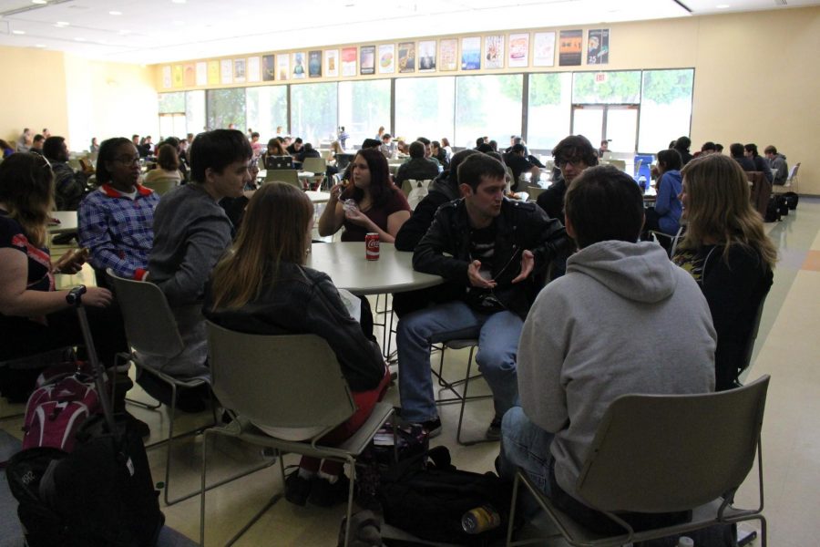 Tucker Boze, 19, history major, and friends discuss the experience of being locked in the bookstore during the brief power outage. Photo credit: Shahni Ben-Haim