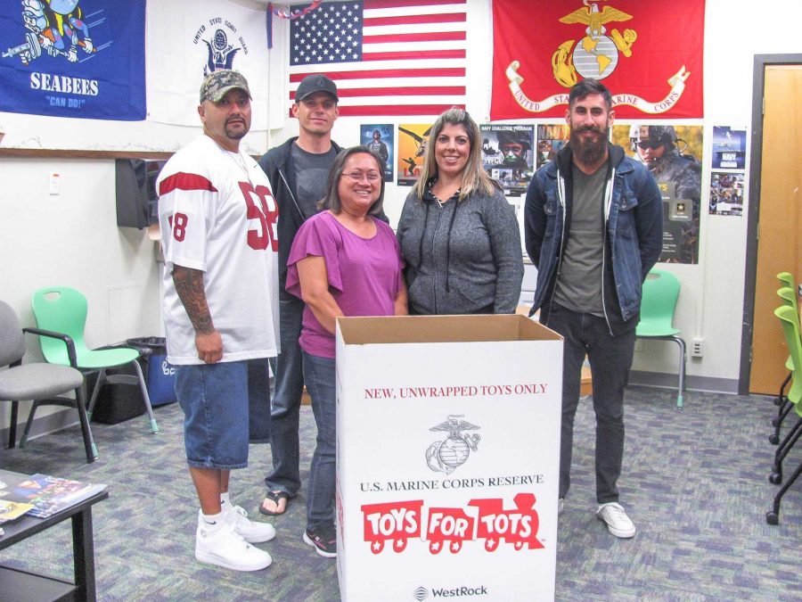 (From left) Staff Sgt. Robert Felix, Samuel Cash, veteran, Maria Martin, Certifying Official, Giselle Ramirez, Veterans Counselor, and Renzo Poblet in the Veterans Resource Center with Toys for Tots. Photo credit: Julien Levangie