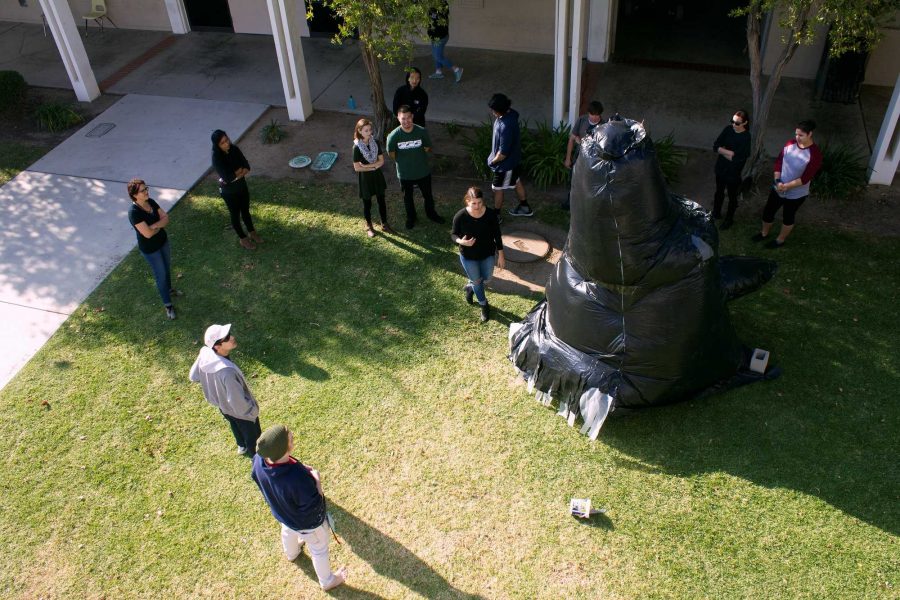 Student gather around inflatable wolf-head sculpture. Photo credit: Janett Perez