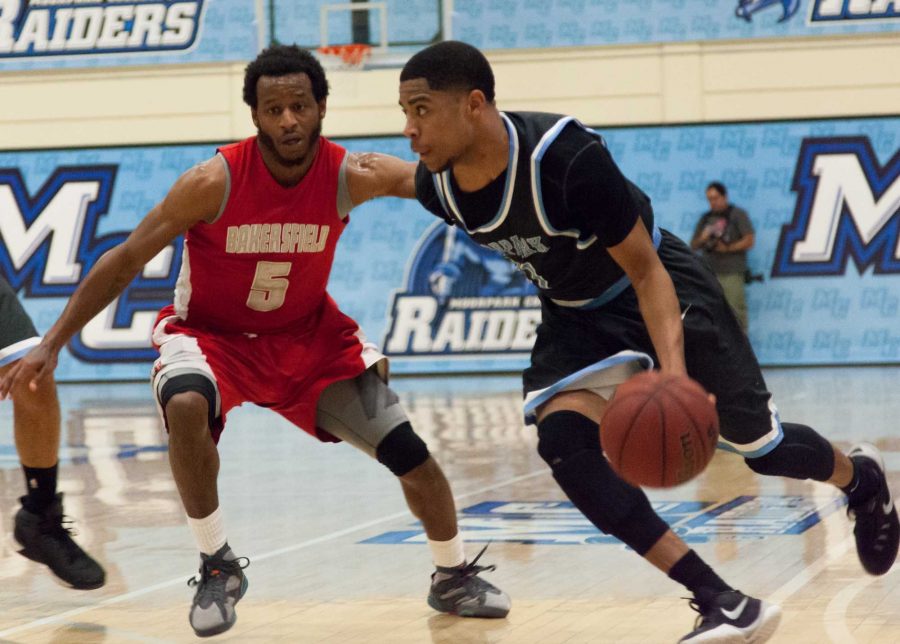 Moorpark Raider Larry Bush, no. 21, moves past James Pendleton, no. 5, of the Bakersfield College Renegades during the first playoff game Friday night at the Raider Pavilion. The Raiders kept the game close but ultimately lost 96-78. Photo credit: Willem Schep