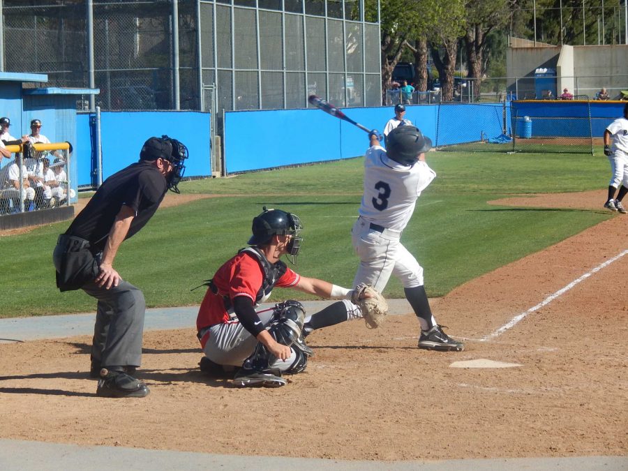 Infielder Garrett Kueber hits a base hit to drive in the final run of the game in the sixth inning against SBCC on Saturday. The Raiders won 6-4. Photo credit: Brian King
