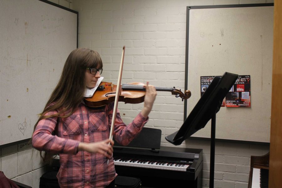 Bronte Vlashi, 14-year-old music major, practices her violin. Photo credit: America Castillo