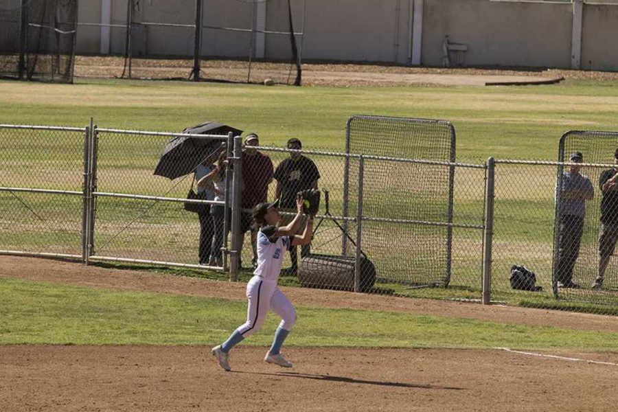 Alisson Ramirez (#5) of Moorpark College catches a pop fly ball to make the first out in the top of the 7th inning against LA Harbor on Saturday, February 20, 2016. Moorpark won 7-0.