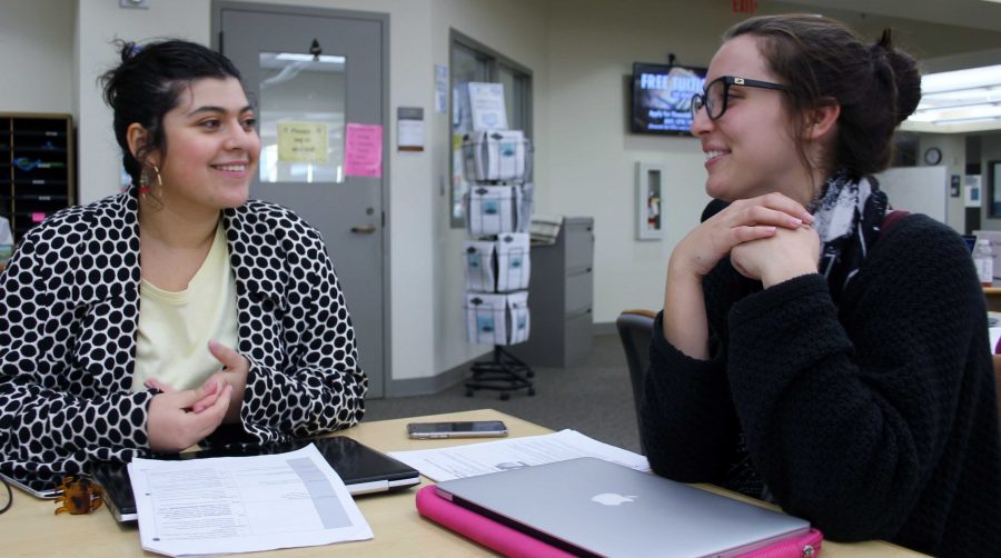 Eden Kol, left, a writing tutor, talks about essay writing with Kara Frank, 21, sociology major. The Writing Center can work individually with students to work on their scholarship essay. Photo credit: Son Ly