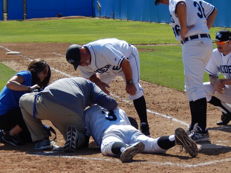 Injured batter Garrett Kueber is attended to by Moorparks physical therapy staff after he was hit in the face by a pitch in the game against Oxnard College, Saturday. Photo credit: Brian King