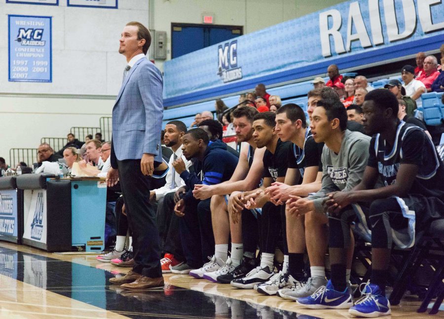 Raiders Head Coach Gerred Link stands in front of his players watching the action on the court. Photo taken Feb. 27. Photo credit: Willem Schep