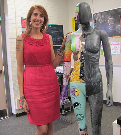 Rachel Sherwyn, program director at a treatment center, stands next to kaleidoscope, an artistic figure that represents an individual with an eating disorder on March 3, in PS 202.  Sherwyn gave her talk on “The Reality of Eating Disorders” on the same day.