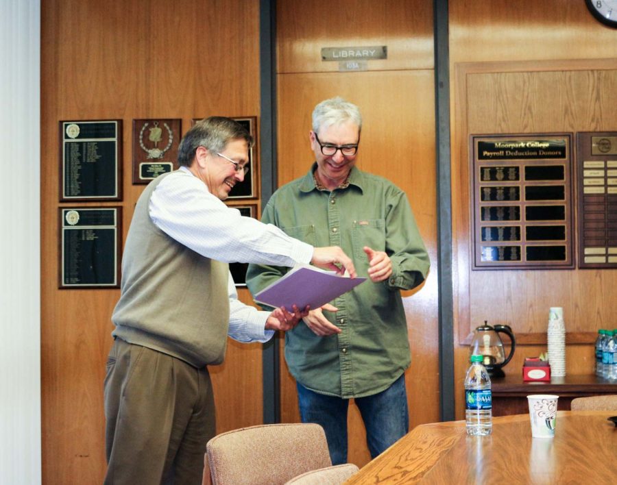 Stephen Callis, left, recieves an award for newly tenure faculty from Moorpark College President Luis Sanchez on March 30.