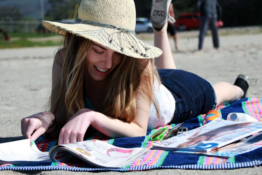Depicting the idea of relaxing on the beach while enjoying reading magazines. Photo credit: photo illustration: Kristen Schulte