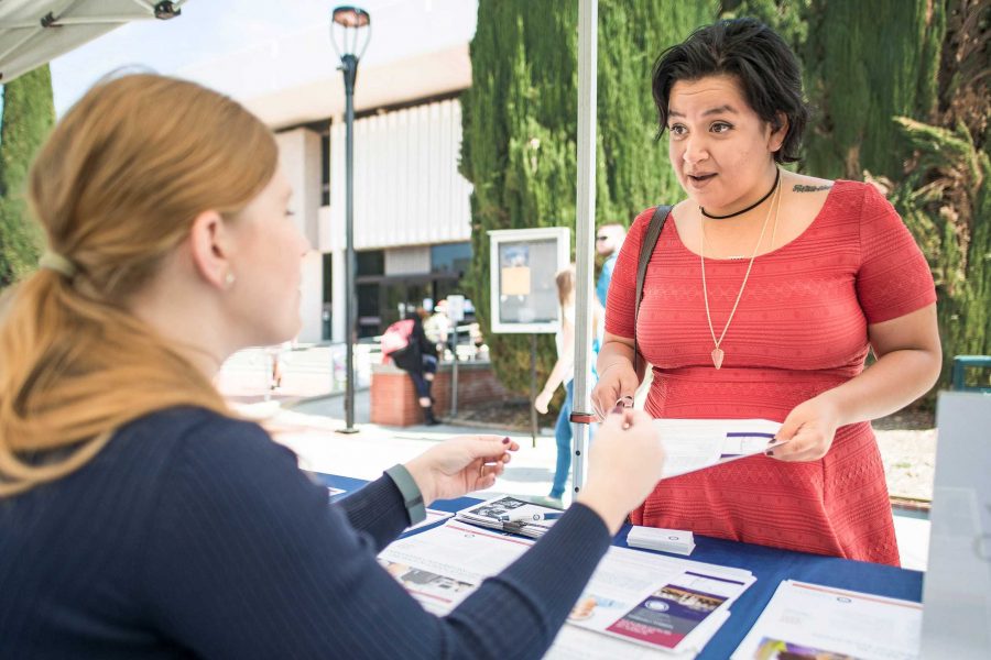 Daniela Vitela, Nursing major, discusses college information with a National University representative.