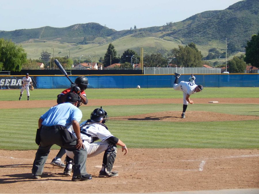 John Cashman pitching to the Pierce College batter in the seventh inning at Raiders Stadium on Thursday. He gave up four hits and two runs in seven innings of work to earn the win. Photo credit: Brian King