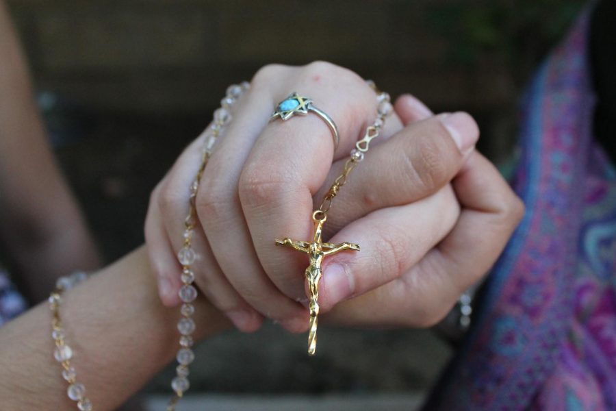 Photo Illustration depicting two religions coming together in unity, one being represented by the Jewish star and the other being the rosary commonly seen in Catholic tradition. Photo credit: Kayla Colon