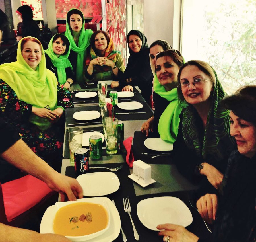 Women sit in a cafe in Tehran, Iran. The culture surrounding womenswear, including scarves such as the ones depicted, has become less conservative in recent years. Photo credit: Nancy Gallgher