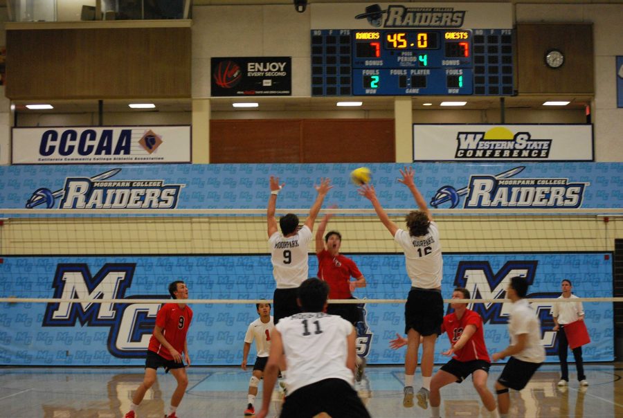 Drake+Uthe%2C+9%2C+and+Zach+Erickson%2C+16%2C+go+up+at+the+net+to+block+a+ball.+Photo+credit%3A+Spencer+White