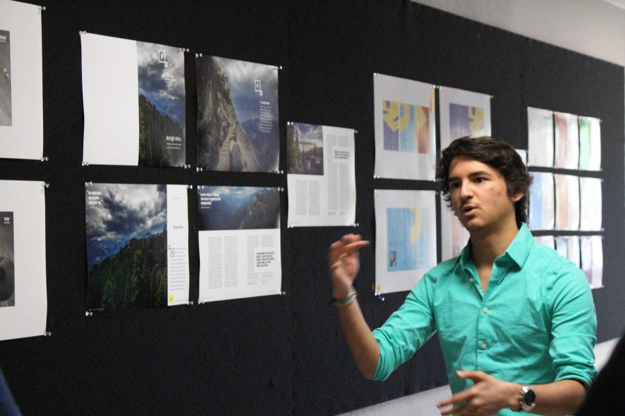 Graphic+design+student+Diego+Buller+explains+his+editorial+design+that+was+presented+with+the+Overall+Body+of+Work+award.+Photo+credit%3A+Casey+Ahern