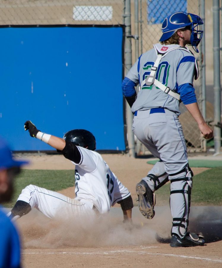 Jesse Aucelluzzo of the Moorpark Raiders sliding into home plate while Logan Gillaspie of the Oxnard Condors waits for the ball to be thrown to him during the seventh inning of their game at Moorpark College on April 21. The Raiders went on to get 5 runs during that inning and won their final game at home 11-4.
