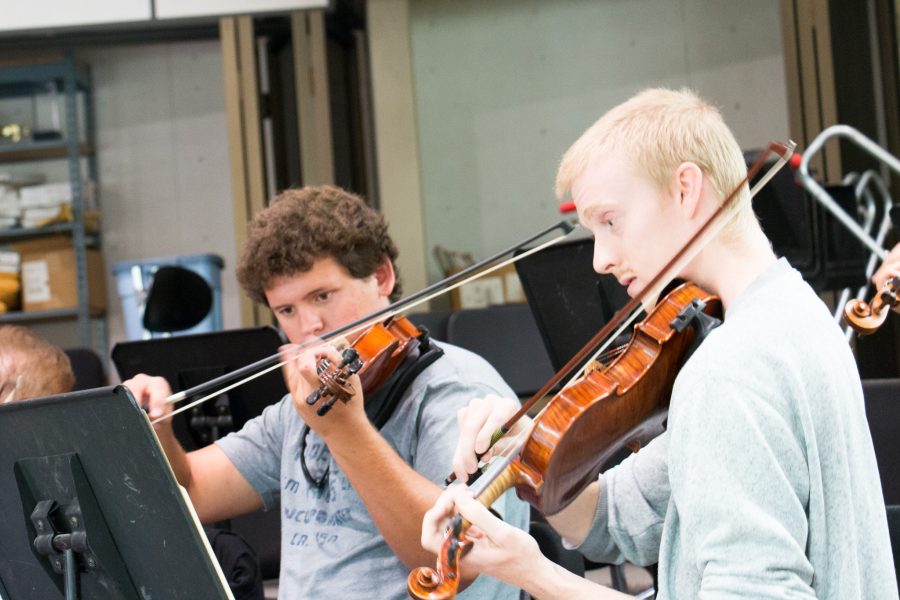 Political science major Andre Warwar, 20, and chemical engineering major Robert Wadell, 21, practice playing their violins during a rehearsal for the Moorpark College Symphony Orchestras performance of Beethovens 2nd Symphony in the Music Building, Moorpark College, Sept. 15, 2016. Photo credit: Francisco Molina
