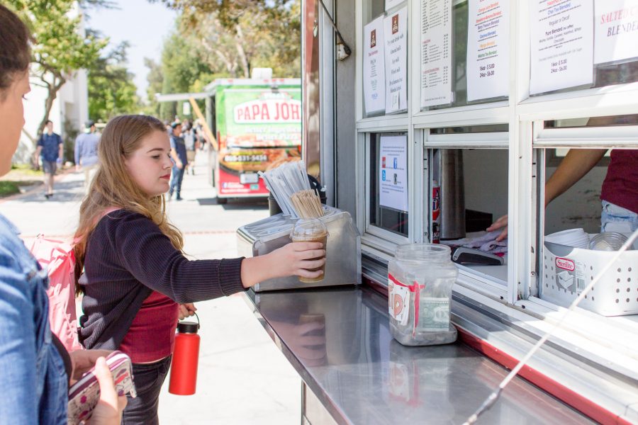 Nineteen-year-old film major Hannah Lynch grabs her drink from Matts Coffee Express food truck just off Raider Walk at Moorpark College on Sept. 6, 2016. New food trucks have increased students options for lunch on campus. Photo credit: Willem Schep