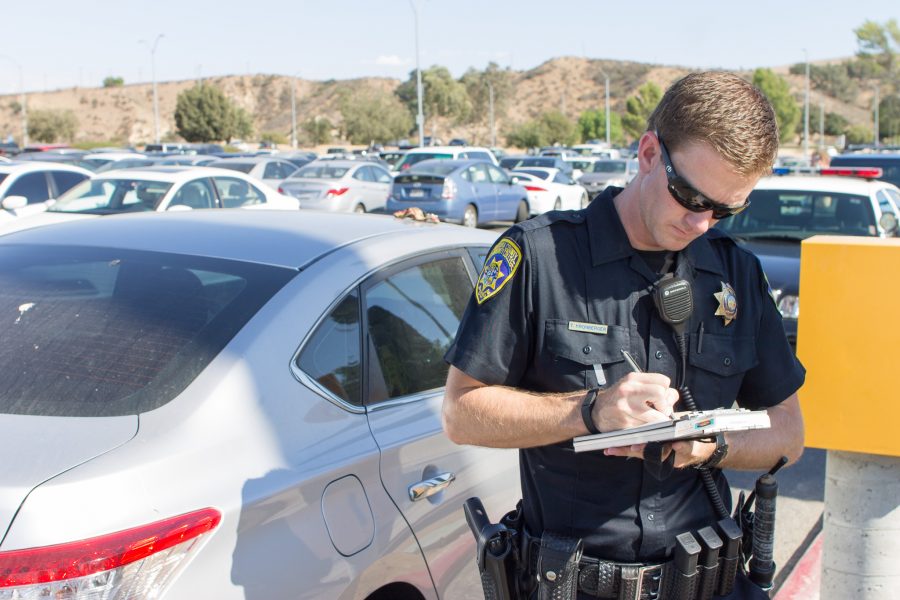 Moorpark College Police Officer Taylor Kronberger carries out paperwork after finding a student with possession of marijauna in his vehicle in the north campus parking lot, Sept. 29. Students unaware of the severity of punishments for weed possession may be surprised. Photo credit: Willem Schep