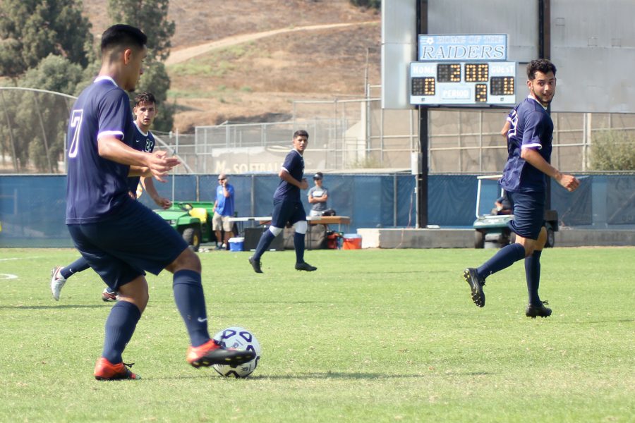 Midfielder Carlos Lemus looks to pass, as his teammates Nicholas Wiseman, David Jimenez, and Oscar Ramos look on in the season opener on Aug. 26 at Moorpark College. Aside from the season opener, all of the new teams games have been on the road, providing an opportunity for the teammates to bond. Photo credit: Misha Goetze