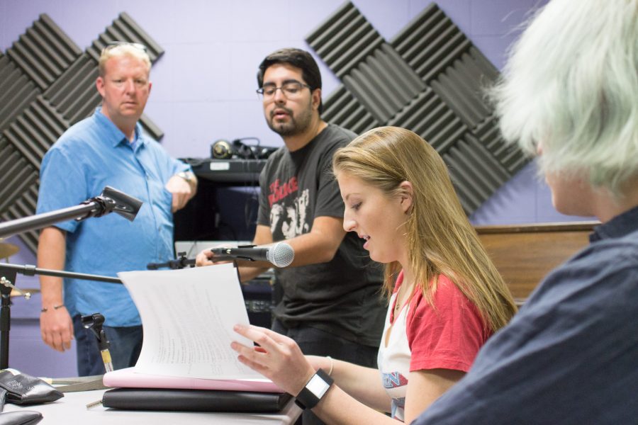 Jason Beaton, left, radio and audio faculty, observes Raul Perez, sound engineer, as he adjusted the microphone for Casey Ahern, Student Voice editor-in-chief, before the recording for the weekly radio show StudentVoiceOnAir started on Aug. 30. Photo credit: Willem Schep
