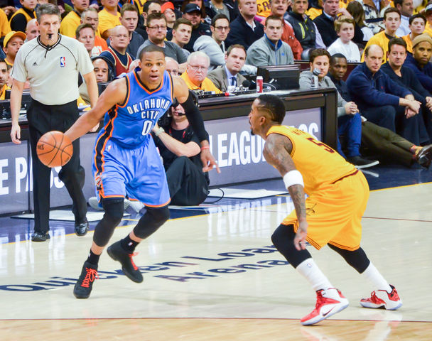 Russell Westbrook of the Oklahoma City Thunder attempts to drive past J. R. Smith of the Cleveland Cavaliers during a 2015 away game in Cleveland. Westbrook is a leading candidate for this years NBA MVP award. Photo credit: Erik Drost