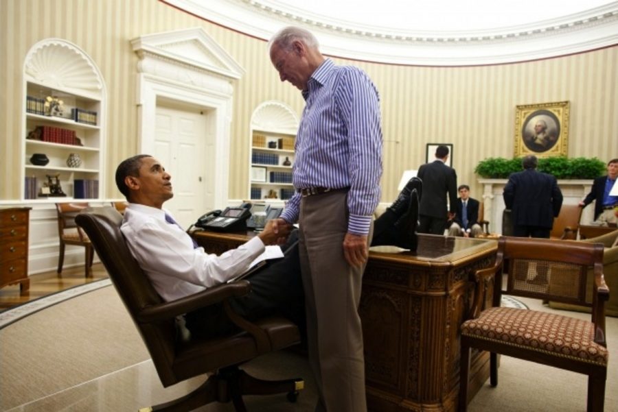 President Barack Obama and Vice President Joe Biden shake hands in the Oval Office following a phone call with House Speaker John Boehner securing a bipartisan deal to reduce the nations deficit and avoid default, 2011. Memes playing off of the close relationship the President and Vice President have formed have become a popular way of relieving election stress. Photo credit: Pete Souza