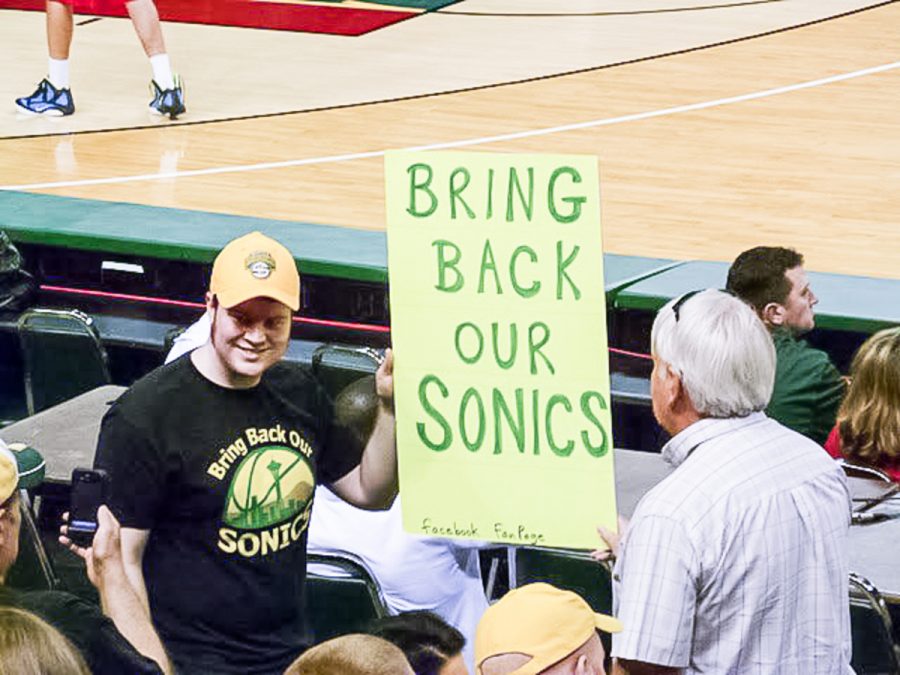 A local fan holds up a sign in support of bringing the Sonics back to Seattle during a charity event in Seattle in 2013. Photo credit: Matthew Addie